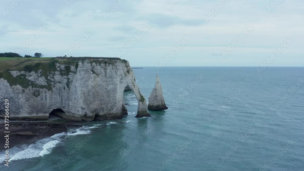 Wide Establishing Shot of Famous Etretat Cliffs with Ruff Ocean Waves on Overcast Day, Aerial Forward Wide Establishing Shot of Famous Etretat Cliffs with Ruff Ocean Waves on Overcast Day, Aerial Forward