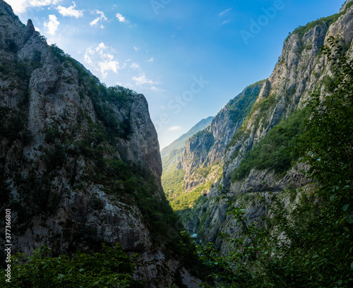 Mochara river canyon in montenegro, high steep mountains and cliffs with dawn rays of the sun, tourism in europe and the balkan peninsula