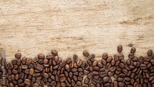 Frame of roasted coffee beans on old wood texture can be use as background 