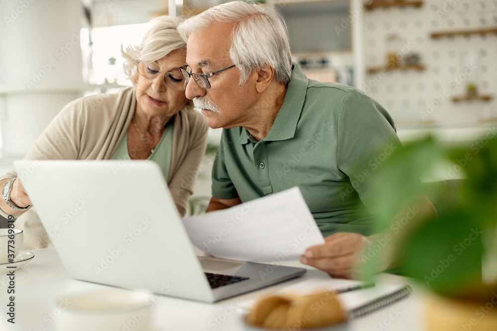 Senior couple analyzing their savings while going through home finances. Senior couple analyzing their savings while going through home finances.