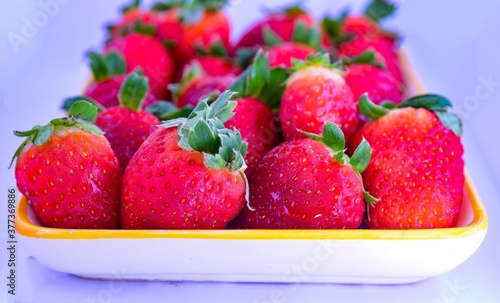 Delicious red strawberries served on a plate  ready to be used in smoothies  salads or tasted one by one