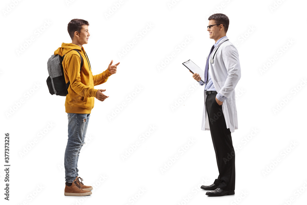 Full length profile shot of a teenage boy talking to a male doctor Full length profile shot of a teenage boy talking to a male doctor