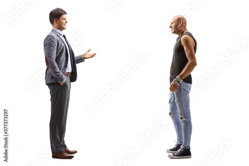 Young man in suit and tie talking to a hipster guy