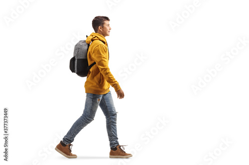 Male teenager in a yellow hoodie walking