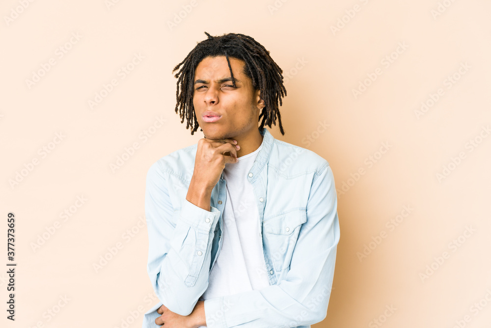 Young african american rasta man suffers pain in throat due a virus or infection. Young african american rasta man suffers pain in throat due a virus or infection.