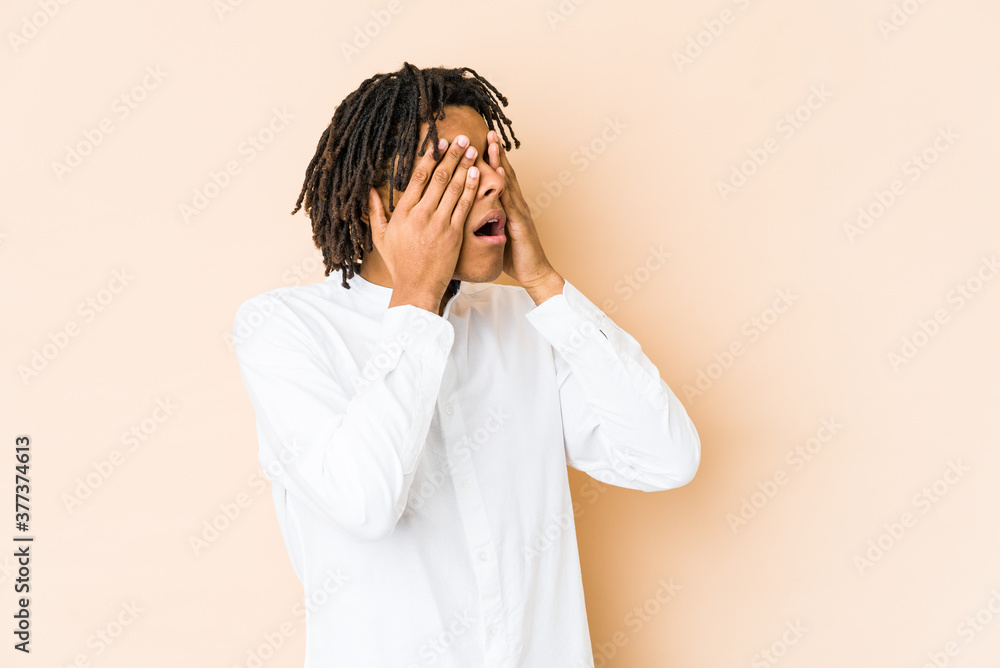 Young african american rasta man afraid covering eyes with hands. Young african american rasta man afraid covering eyes with hands.