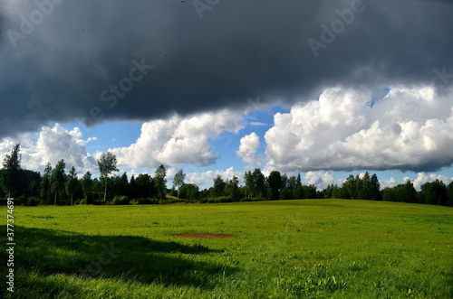 Black storm clouds during summer, Landscape with trees and meadows in the foreground in Latvia. Low clouds © SHARKY PHOTOGRAPHY