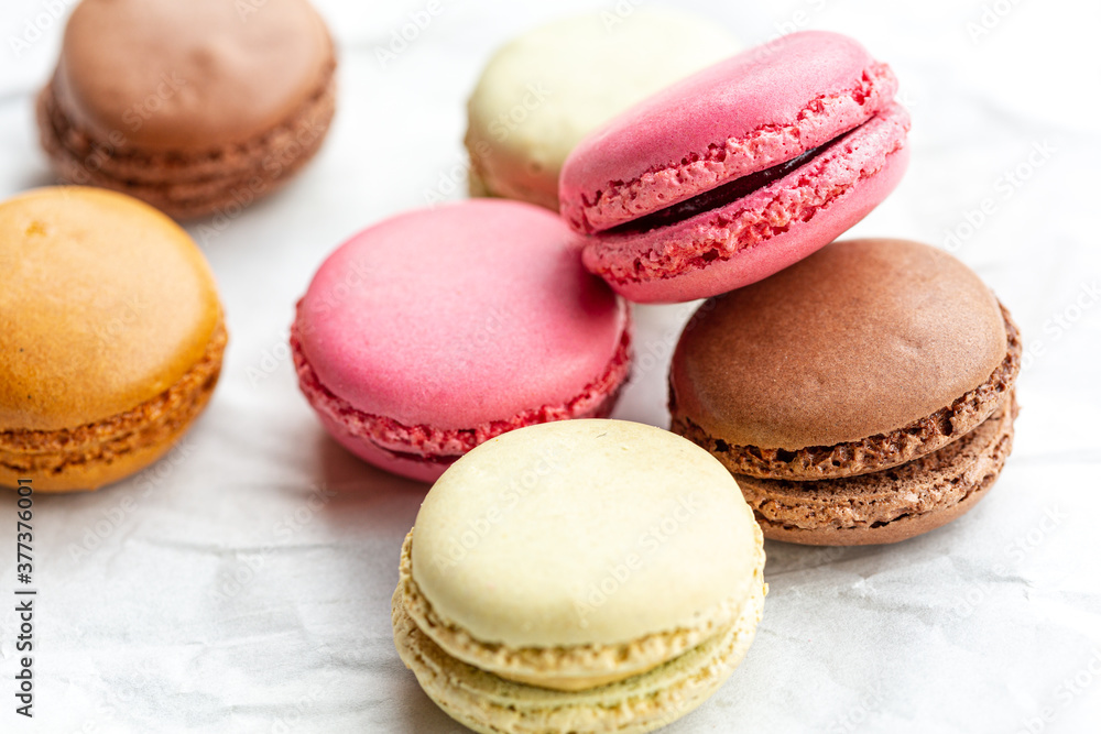 Chocolate, raspberry and Vanilla flavoured french macarons on white background Chocolate, raspberry and Vanilla flavoured french macarons on white background