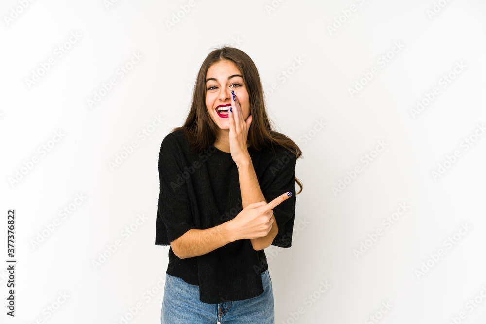 Young caucasian woman isolated on white background saying a gossip, pointing to side reporting something. Young caucasian woman isolated on white background saying a gossip, pointing to side reporting something.