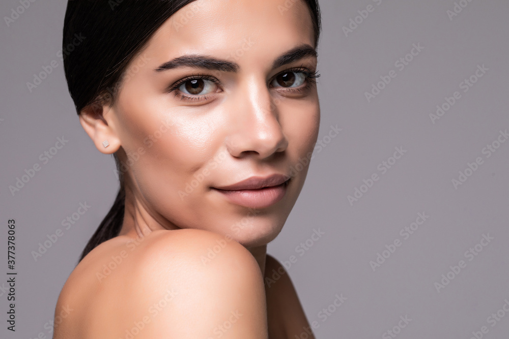 Fototapeta premium Beautiful young woman skincare over gray background