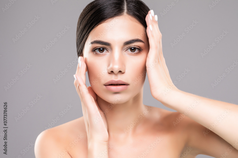 Young pretty woman with beauty skin isolated over gray background