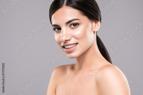 Beauty woman with healthy skin portrait over gray background