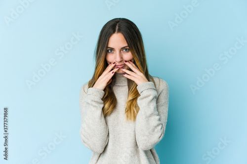 Young caucasian woman isolated on blue background making up plan in mind, setting up an idea.