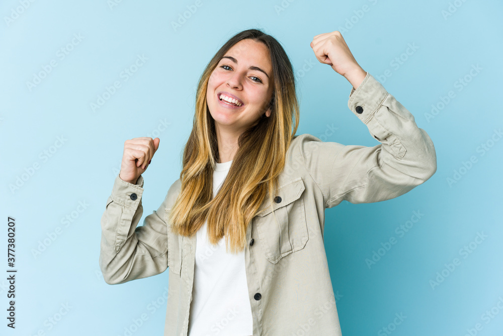 Young caucasian woman isolated on blue background cheering carefree and excited. Victory concept. Young caucasian woman isolated on blue background cheering carefree and excited. Victory concept.