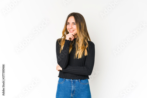 Young caucasian woman isolated on white background relaxed thinking about something looking at a copy space.