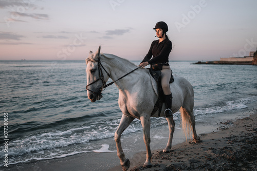 person riding horse on the beach