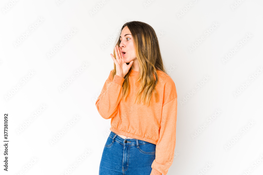 Young caucasian woman isolated on white background is saying a secret hot braking news and looking aside Young caucasian woman isolated on white background is saying a secret hot braking news and looking aside