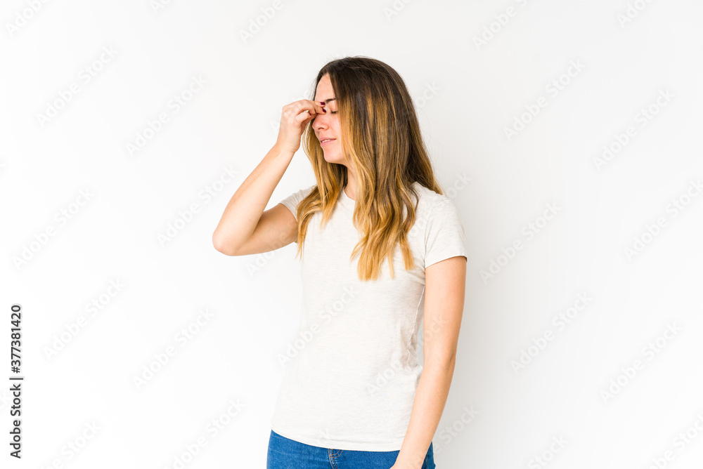 Young caucasian woman isolated on white background having a head ache, touching front of the face. Young caucasian woman isolated on white background having a head ache, touching front of the face.