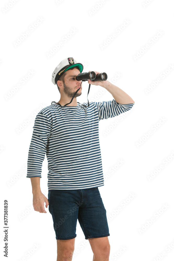 Holding binocular. Caucasian male sailor in uniform on white studio background. Young man using modern devices and gadgets in his work. Concept of tech, professional occupation, job of seaman. Holding binocular. Caucasian male sailor in uniform on white studio background. Young man using modern devices and gadgets in his work. Concept of tech, professional occupation, job of seaman.
