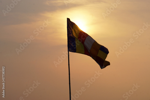 Buddhist flag flying in the sun