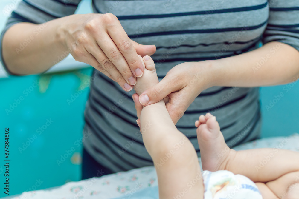 Fototapeta premium Baby massage closeup. Mother and child. Newborn.