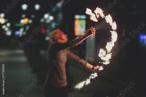 Group of fire artists fakir perform amazing show at night with flamethrowers, fire dancers, chain of fire, extreme breathing photo