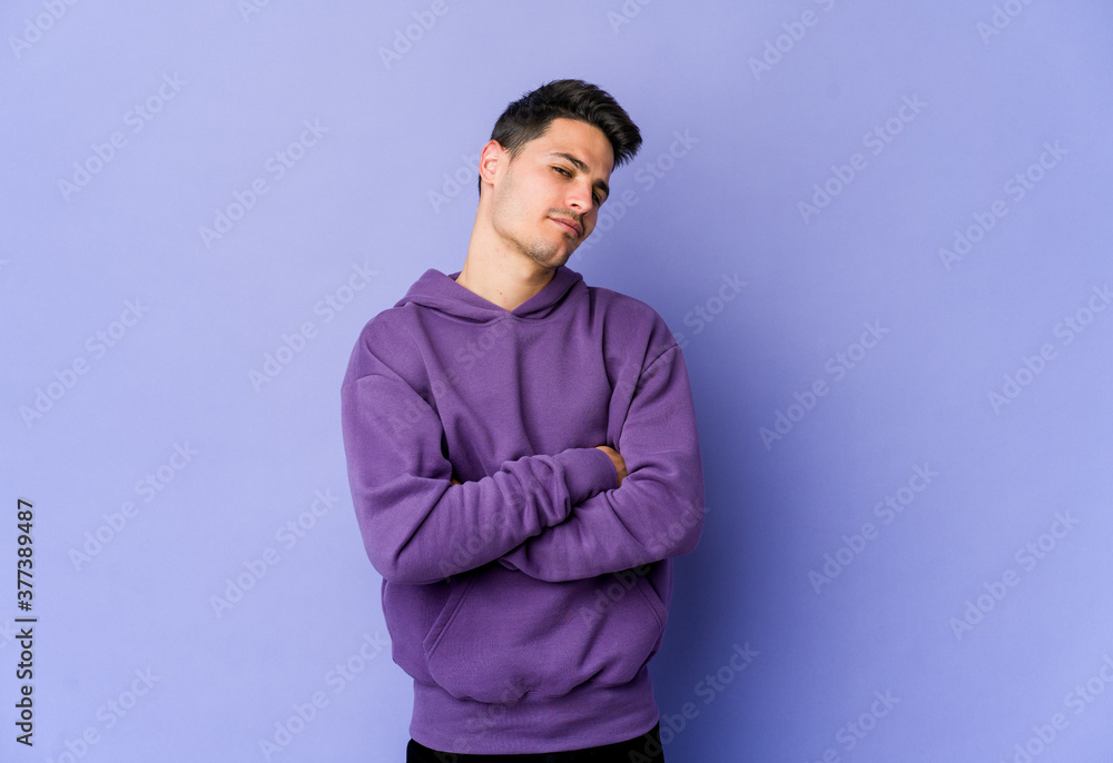 Young caucasian man isolated on purple background suspicious, uncertain, examining you. Young caucasian man isolated on purple background suspicious, uncertain, examining you.