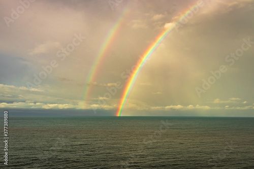 Fototapeta Naklejka Na Ścianę i Meble -  rainbow colorful above sea horizon at dawn