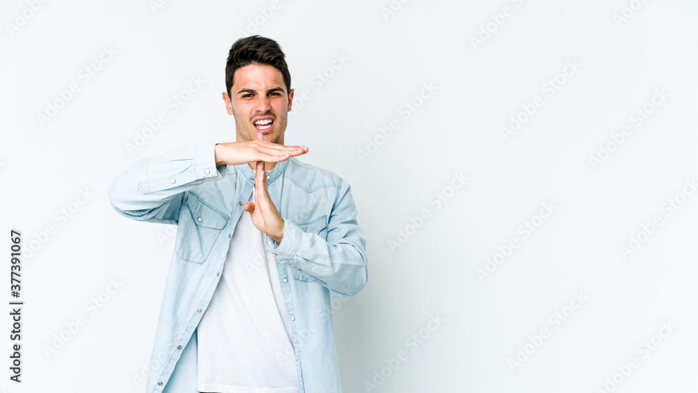 Young caucasian man isolated on white background showing a timeout gesture. Young caucasian man isolated on white background showing a timeout gesture.
