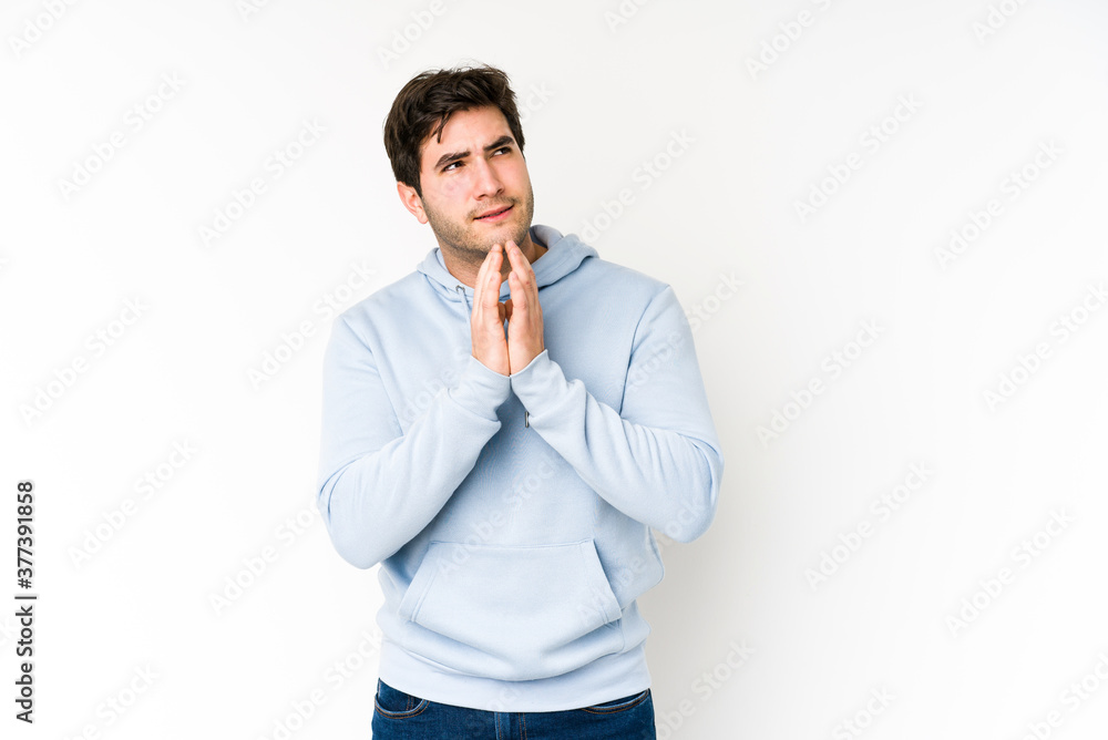 Young man isolated on white background making up plan in mind, setting up an idea. Young man isolated on white background making up plan in mind, setting up an idea.