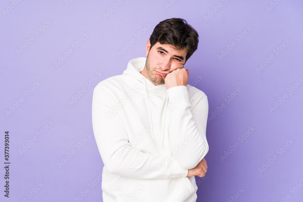 Young man isolated on purple background who feels sad and pensive, looking at copy space. Young man isolated on purple background who feels sad and pensive, looking at copy space.