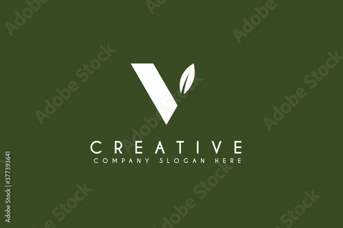 Initial letter V logo design with natural leaf.vector business and branding logo isolated on green background