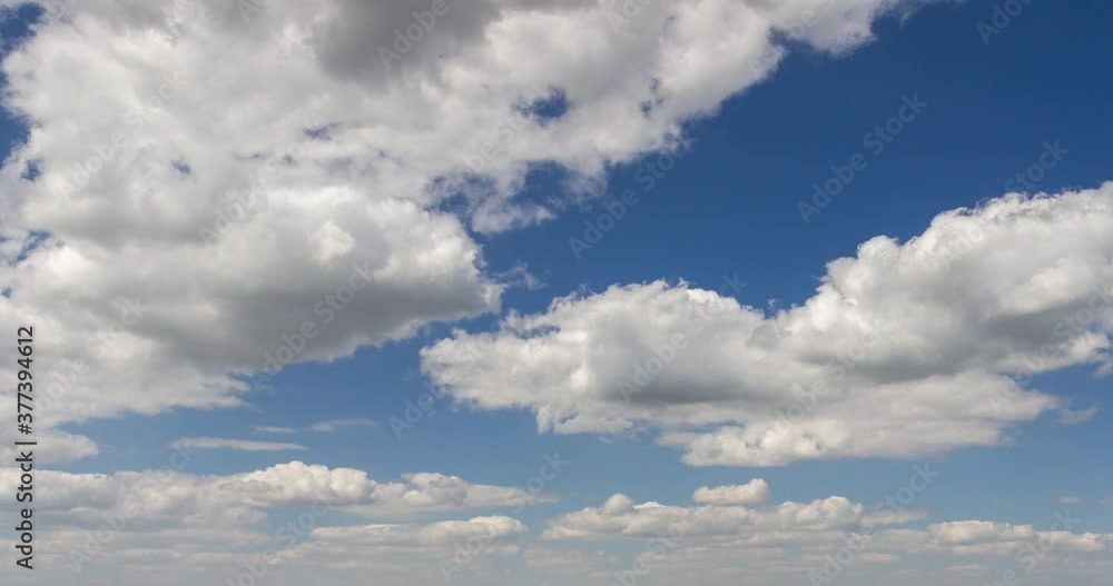 Blue sky with cumulus clouds. Cloudscape in the day. Nature landscape wilderness 4k time lapse. Amazing view.