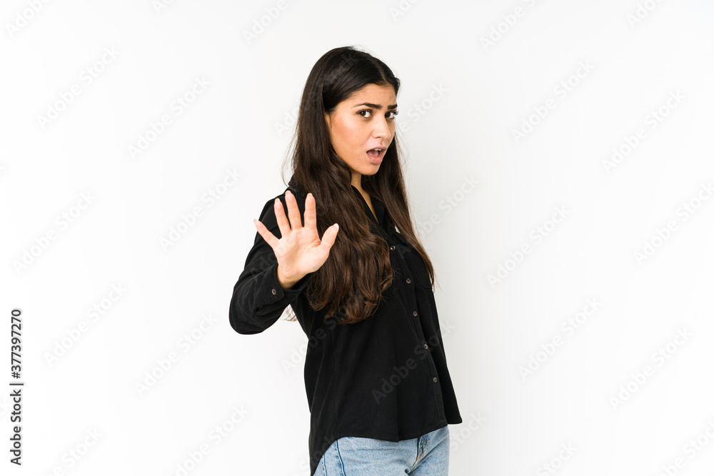 Young indian woman isolated on purple background being shocked due to an imminent danger Young indian woman isolated on purple background being shocked due to an imminent danger