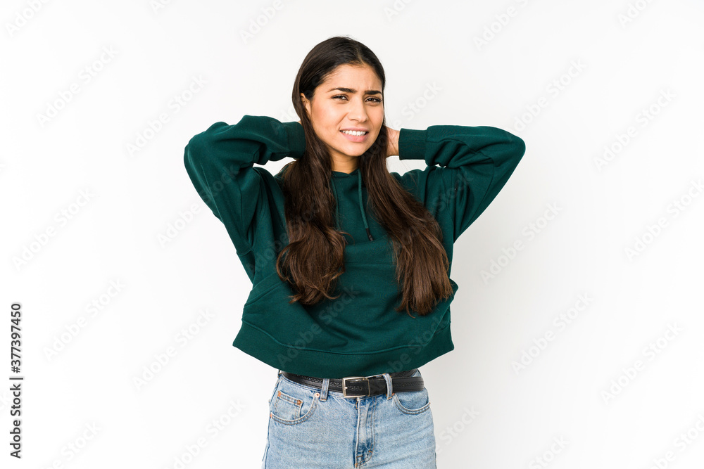 Young indian woman isolated on purple background touching back of head, thinking and making a choice. Young indian woman isolated on purple background touching back of head, thinking and making a choice.