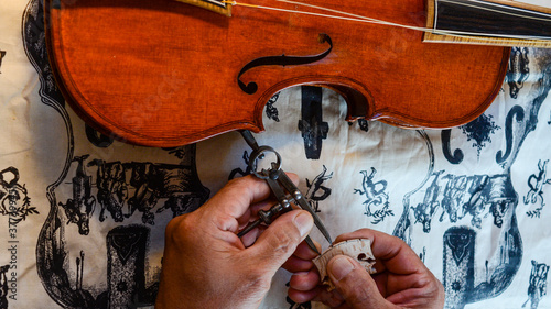 Violin Violin maker luthier changing bridge of a handmade baroque viol