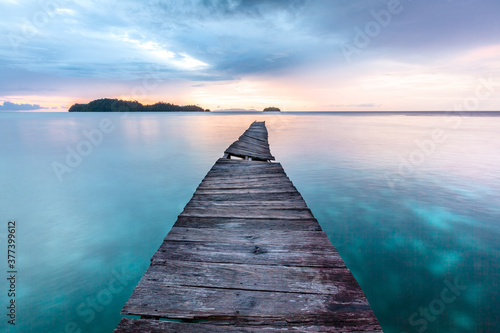 Old wooden pier in Indian ocean. Tropic island. Tranquil sunset landscape  © Katya Tsvetkova 