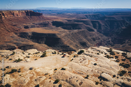 Aerial view of a car on a cliff of a Utah canyon photo