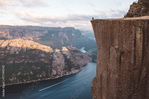 Man sitting at edge of cliff at Preikestolen, Norway