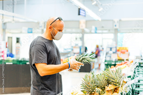 Man buying fresh fruit in supermarket photo