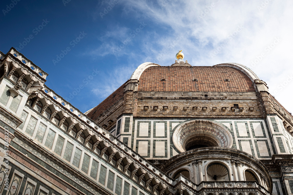 The majestic Brunelleschi's dome seen from below, with blue sky. Santa Maria del Fiore cathedral, Florence, Tuscany, Italy.