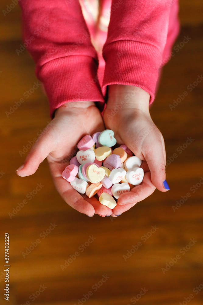 Child's Hands holding candy hearts on Valentine's Day Child's Hands holding candy hearts on Valentine's Day