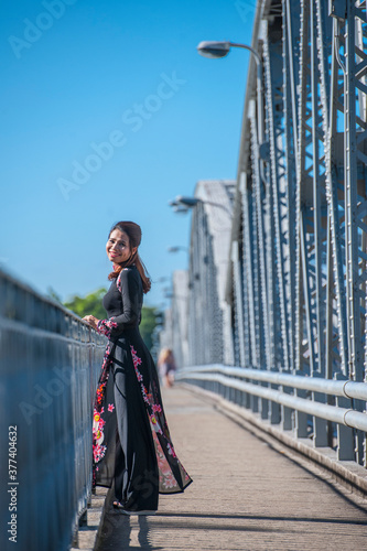 beautiful woman walking over Truong Tien Bridge in Hue / Vietnam photo