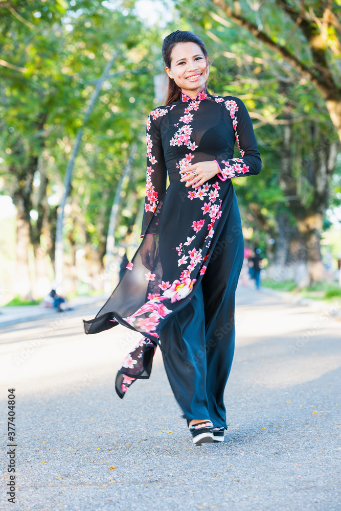 beautiful woman walking through alley in Hue / Vietnam beautiful woman walking through alley in Hue / Vietnam