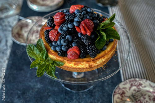 Cheesecake and berries with mint leaves photo