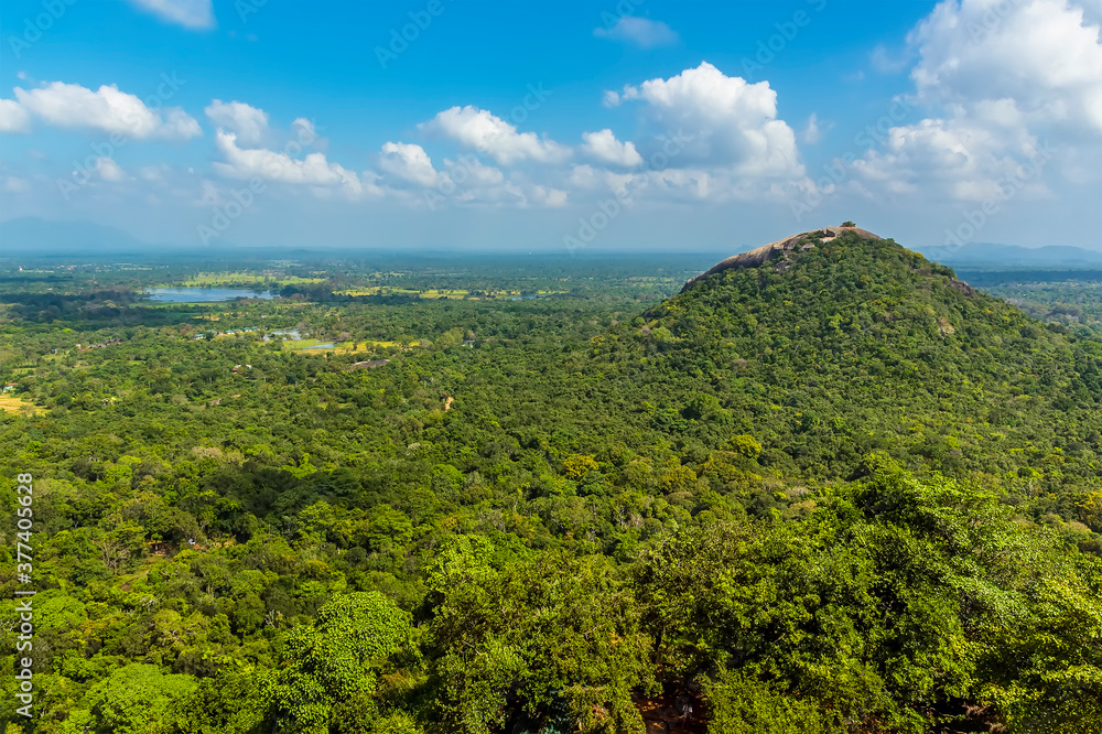 Fototapeta premium A view from the rock fortress of Sigiriya, Sri Lanka towards the adjacent Pidurangala rock formation