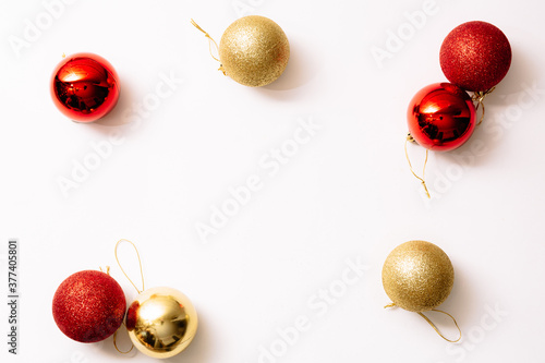 Christmas tree toys isolated on a white background. New year glitter balls red and gold color. Festive banner with place for text in fashion style.