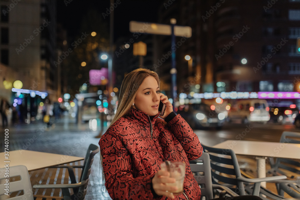 Portrait of woman taking coffee at night on the city. Portrait of woman taking coffee at night on the city.