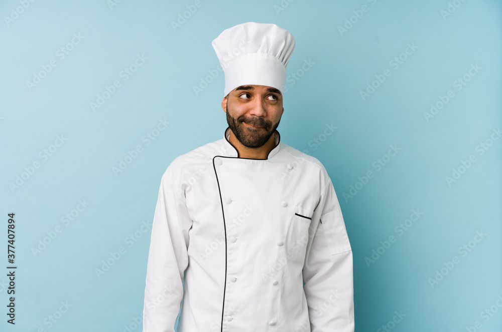 Young latin chef man isolated confused, feels doubtful and unsure. Young latin chef man isolated confused, feels doubtful and unsure.