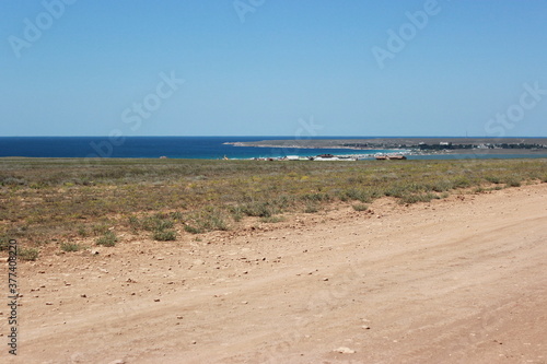 View from the steppe to Olenevka and the Black Sea. Steppe road